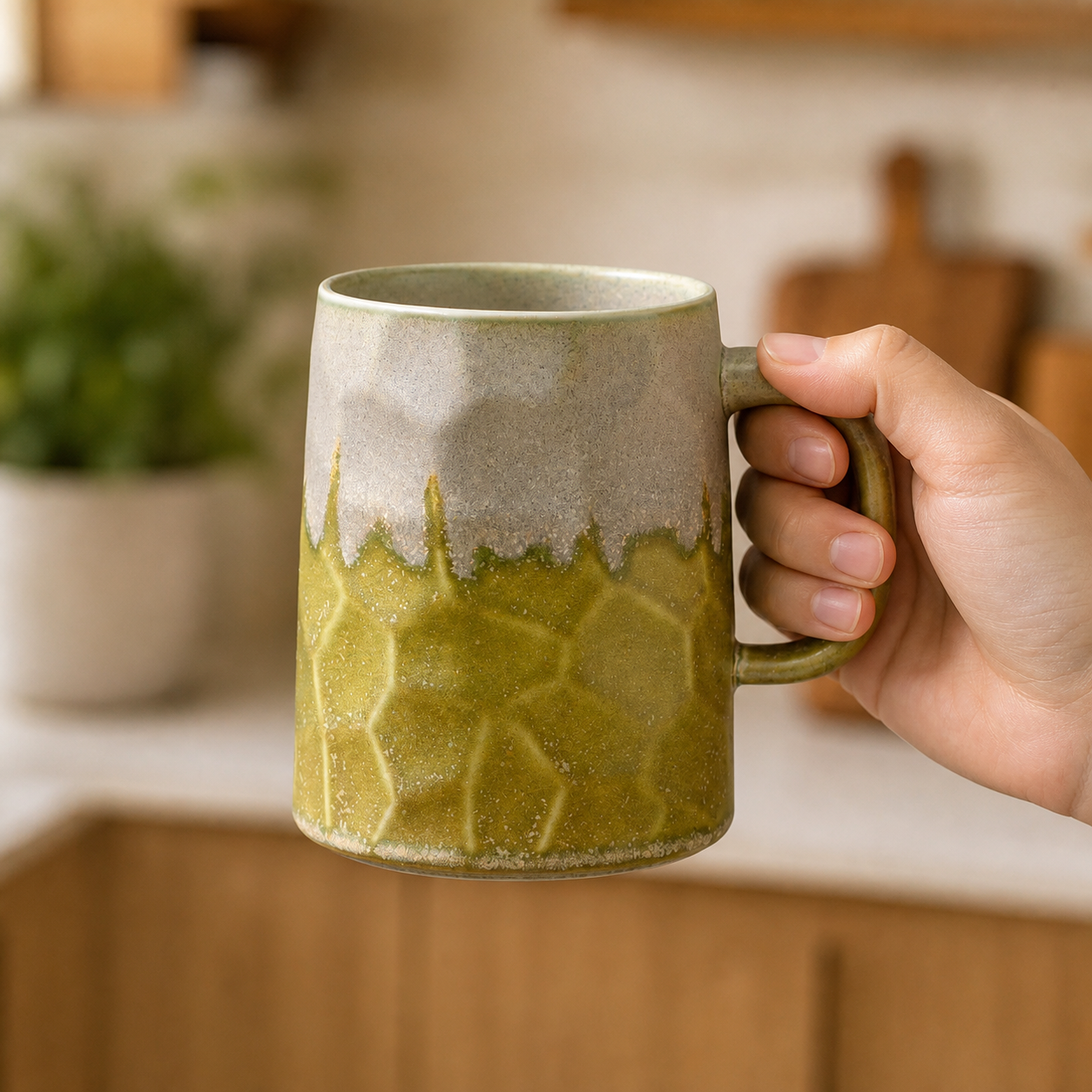 Moss Trace reactive glaze mug, held in hand for scale